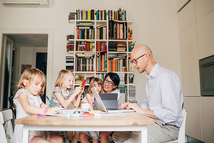 Parents,Indoor,Sitting,Table,Homeschooling,With,Three,Female,Children,-