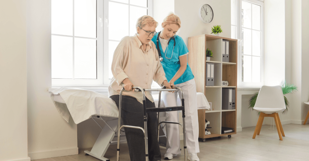 Healthcare professional supports an older adult using a walker during a mobility assessment in a bright clinical care room.