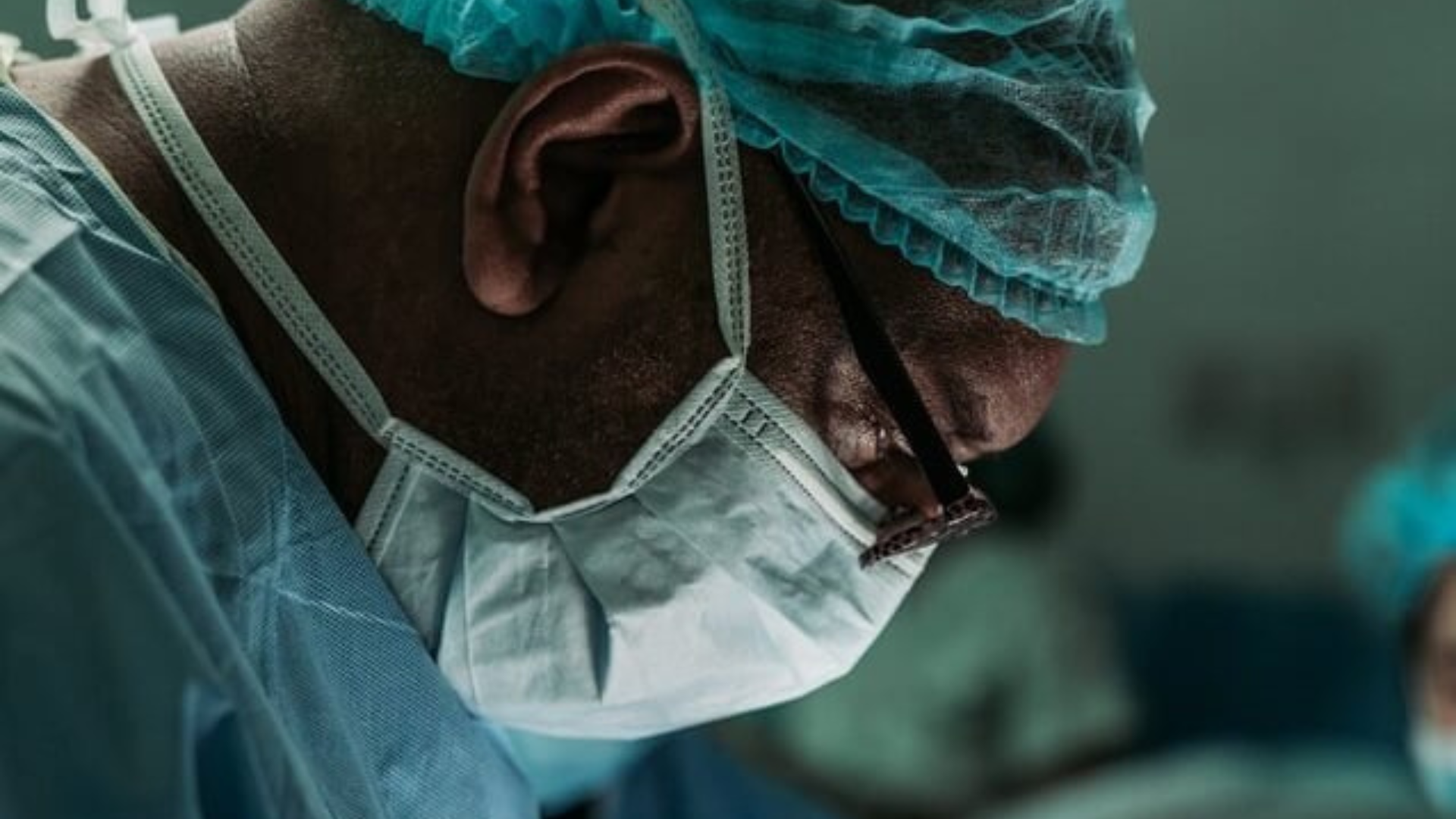 Close-up of a healthcare professional wearing surgical protective equipment during a procedure.